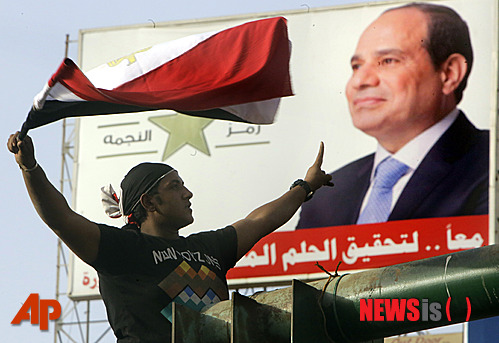 【카이로=AP/뉴시스】3일(현지시간) 한 이집트 남성이 카이로 타흐리르광장에서 이번 대선에 승리한 압델 파타 엘 시시 전 국방장관을 지지하고 있다. 2014.06.04