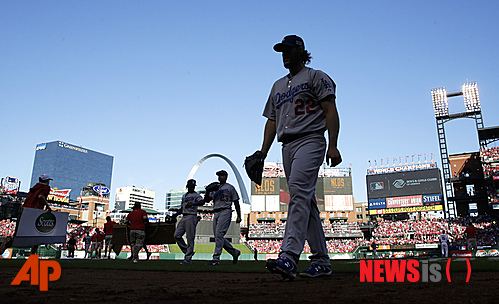 Los Angeles Dodgers starting pitcher Clayton Kershaw walks to the dugout after pitching the fourth inning in Game 4 of baseball's NL Division Series against the St. Louis Cardinals, Tuesday, Oct. 7, 2014, in St. Louis. (AP Photo/Charles Rex Arbogast)