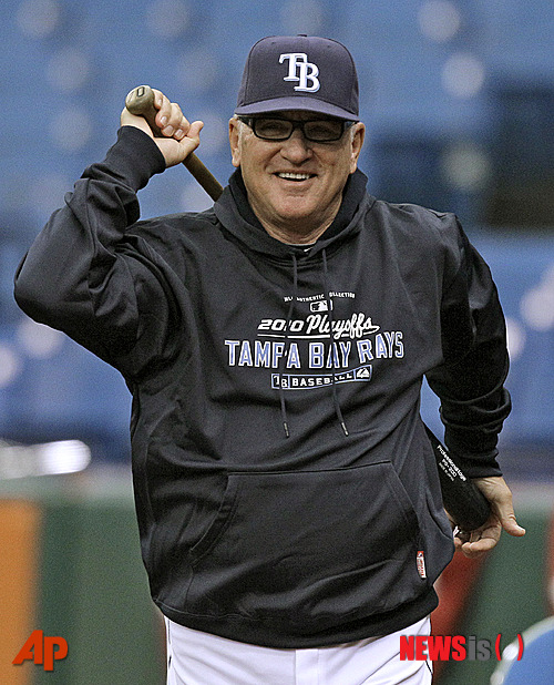 FILE - In this Oct. 5, 2010, file photo, Tampa Bay Rays manager Joe Maddon smiles as he looks on during baseball practice in St. Petersburg, Fla. The Rays announced Friday, Oct. 24, 2014, that Maddon has exercised an opt-out in his contract, which was due to expire after next season. (AP Photo/Chris O'Meara, File)