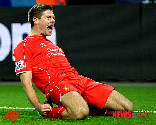 FILE - This is a Tuesday, Dec. 2, 2014  file photo of Liverpool's Steven Gerrard as he celebrates scoring against Leicester during the English Premier League soccer match between Leicester City and Liverpool at King Power Stadium, in Leicester, England. Liverpool captain Steven Gerrard is set to move to a foreign club after disclosing on Friday Jan. 2, 2015 he will leave his boyhood team after the season to seek a new football experience away from the English Premier League. The 34-year-old midfielder said he "agonized" over whether to accept Liverpool's offer of a new contract, and made the announcement midway through a season when he was no longer guaranteed a place in the team. (AP Photo/Rui Vieira, File)