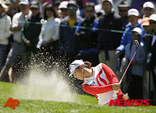 Lydia Ko, of New Zealand, hits the ball out of a bunker up to the first green of the Lake Merced Golf Club during the final round of the Swinging Skirts LPGA Classic golf tournament Sunday, April 26, 2015, in Daly City, Calif. (AP Photo/Eric Risberg)