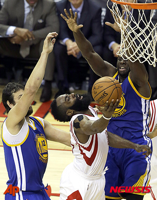 Houston Rockets guard James Harden (13) shoots as Golden State Warriors center Andrew Bogut (12) and forward Draymond Green (23) defend during the second half in Game 4 of the NBA basketball Western Conference finals Monday, May 25, 2015, in Houston. (AP Photo/Pat Sullivan)