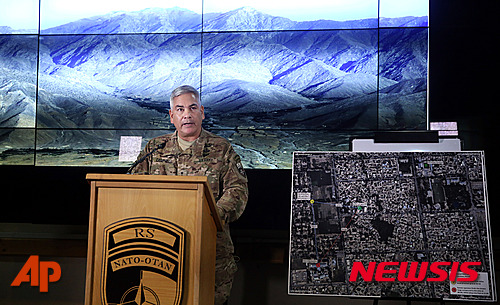 Commander of U.S. and NATO forces in Afghanistan, General John F. Campbell speaks during a press conference at the Resolute Support Headquarters in Kabul, Afghanistan, Wednesday, Nov. 25, 2015. A map of Kunduz city is seen at right. (AP Photos/Massoud Hossaini, Pool)