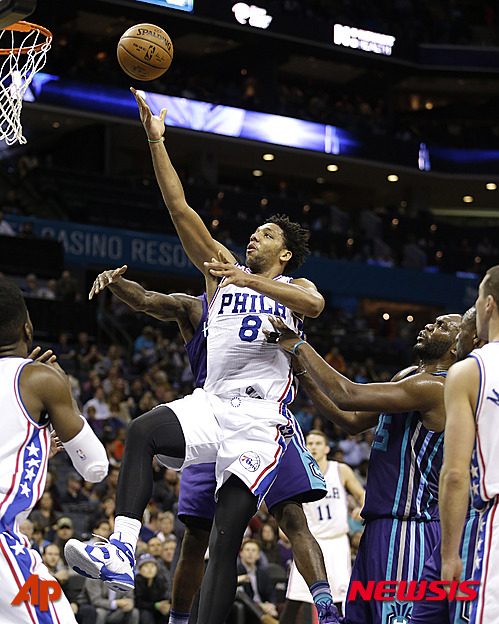 FILE - In this photo taken on Nov. 20, 2015, Philadelphia 76ers' Jahlil Okafor (8) slips through the lane and past a host of Charlotte Hornets as he scores in the second half of an NBA basketball game in Charlotte, N.C. Boston police say they do not plan to investigate an apparent nightclub scuffle involving Okafor unless someone involved comes forward to say they were the victim of a crime. Officer James Kenneally said Friday, NOv. 27, that police responded to reports of a fight outside the nightclub hours after the winless Sixers lost to the Boston Celtics on Wednesday night. But Kenneally says the participants were gone by the time officers arrived and nobody was arrested or charged. (AP Photo/Bob Leverone, File)