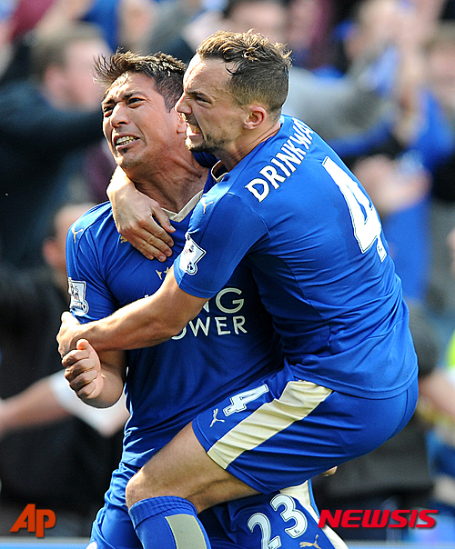 FILE - In this Sunday, April 17, 2016 file photo Leicester City's Leonardo Ulloa celebrates with teammates Leicester City's Danny Drinkwater after scoring a last minute penalty during the English Premier League soccer match between Leicester City and West Ham United at the King Power Stadium in Leicester, England. Bought from second-division team Brighton in 2014, Ulloa goal tally of 13 helped Leicester retain its Premier League status last season. His role has been reduced with the arrival of Okazaki this time around, but his decisive strike in the 1-0 win against Norwich in February could prove crucial to securing the title. (AP Photo/Rui Vieira, File)