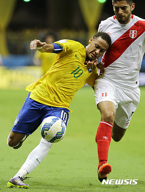 FILE - In this Nov. 17, 2015, file photo, Brazil's Neymar, left, fights for the ball with Peru's Carlos Zambrano during a 2018 World Cup qualifying soccer match in Salvador, Brazil.