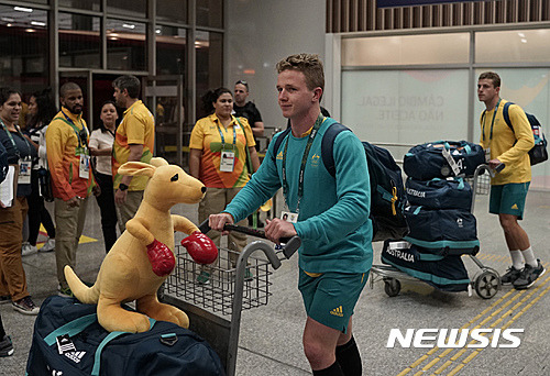Australia's olympic athletes arrive to the Tom Jobim International Airport, in Rio de Janeiro, Brazil, Tuesday, July 26, 2016. Two days after describing the housing at the Rio de Janeiro Olympics as "dangerous," Australian athletes and staff started moving into the massive athletes' village compound on Tuesday. Australia team spokesman Mike Tancred said up to 60 delegation members 
