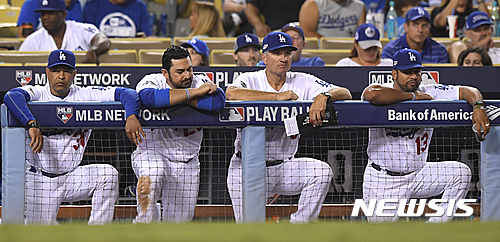 The Los Angeles Dodgers bench watches during the eighth inning of Game 5 of the National League baseball championship series against the Chicago Cubs Thursday, Oct. 20, 2016, in Los Angeles. (AP Photo/Mark J. Terrill)