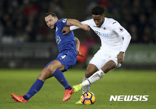 Leicester City's Daniel Drinkwater, left, and Swansea City's Kyle Naughton battle for the ball during the English Premier League match Swansea against Leicester at the Liberty Stadium, Swansea, Wales, Sunday Feb. 12, 2017. (Nick Potts/PA via AP)