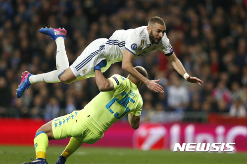Real Madrid's Karim Benzema jumps over Napoli goalkeeper Pepe Reina during the Champions League round of 16, first leg, soccer match between Real Madrid and Napoli at the Santiago Bernabeu stadium in Madrid, Wednesday Feb. 15, 2017. (AP Photo/Daniel Ochoa de Olza)