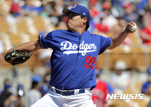 Los Angeles Dodgers starting pitcher Hyun-Jin Ryu (99) throws against the Los Angeles Angels during the first inning of a spring training baseball game, Saturday, March 11, 2017, in Phoenix. (AP Photo/Matt York)