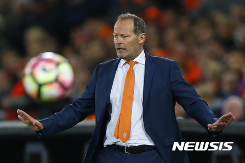In this Friday, Oct. 7, 2016, image Netherlands' coach Danny Blind gestures to his players as the ball goes out during the World Cup Group A qualifying soccer match against Belarus in De Kuip stadium Rotterdam, Netherlands. The Dutch football association fired national coach Danny Blind on Sunday, a day after his team's humiliating 2-0 defeat to Bulgaria in a World Cup qualifier in Sofia. (AP Photo/Peter Dejong)