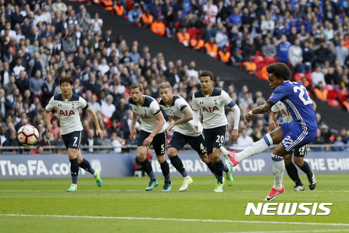 Chelsea's Willian scores his side's second goal from a penalty conceded by Tottenham Hotspur's Son Heung-min, left, during the English FA Cup semifinal soccer match between Chelsea and Tottenham Hotspur at Wembley stadium in London, Saturday, April 22, 2017. (AP Photo/Kirsty Wigglesworth)