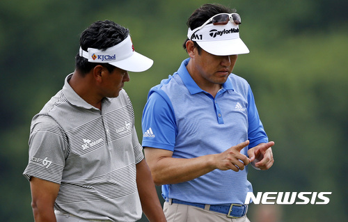 K.J. Choi, left, of South Korea, and teammate and compatriot Charlie Wi discuss their shot on the 17th hole, during the second round of the PGA Zurich Classic golf tournament's new two-man team format at TPC Louisiana in Avondale, La., Friday, April 28, 2017. (AP Photo/Gerald Herbert)