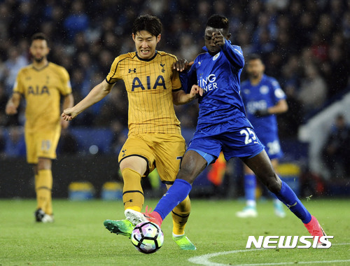 Tottenham's Son Heung-min, left, and Leicester's Wilfred Ndidi battle for the ball during the English Premier League soccer match between Leicester City and Tottenham Hotspur at the King Power Stadium in Leicester, England, Thursday, May 18, 2017. (AP Photo/Rui Vieira)