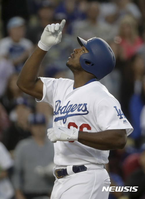 Los Angeles Dodgers' Yasiel Puig celebrates after his two-run home run against the Miami Marlins during the second inning of a baseball game in Los Angeles, Thursday, May 18, 2017. (AP Photo/Chris Carlson)