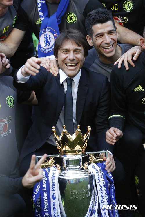 Chelsea's manager Antonio Conte cheers with the trophy after the English Premier League soccer match between Chelsea and Sunderland at Stamford Bridge stadium in London, Sunday, May 21, 2017. (AP Photo/Frank Augstein)