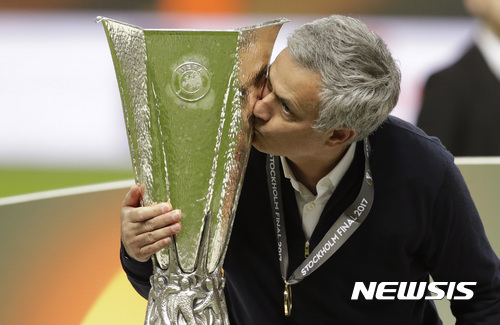 Manchester manager Jose Mourinho kisses the trophy after winning 2-0 during the soccer Europa League final between Ajax Amsterdam and Manchester United at the Friends Arena in Stockholm, Sweden, Wednesday, May 24, 2017. (AP Photo/Michael Sohn)