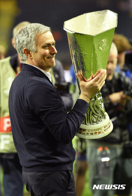 United manager Jose Mourinho holds the trophy after winning the soccer Europa League final between Ajax Amsterdam and Manchester United at the Friends Arena in Stockholm, Sweden, Wednesday, May 24, 2017. United won 2-0. (AP Photo/Martin Meissner)