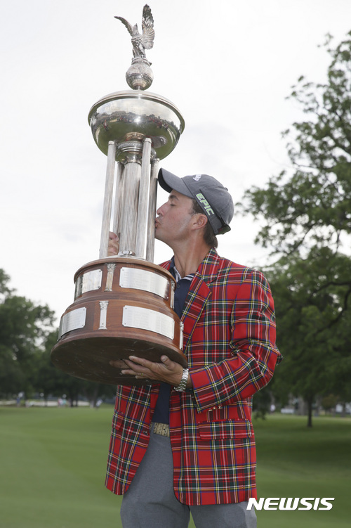 Kevin Kisner kisses the championship trophy after winning the Dean & DeLuca Invitational golf tournament at Colonial Country Club in Fort Worth, Texas, Sunday, May 28, 2017. (AP Photo/LM Otero)