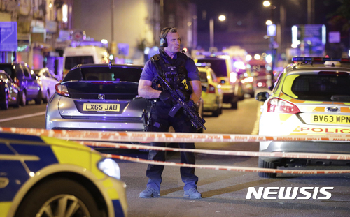 【런던=AP/뉴시스】차량 한 대가 행인들을 덮쳐 여러 명이 부상한 런던 핀스베리 공원 인근 세븐 시스터스 도로에서 19일(현지시간) 무장한 런던 경찰 한 명이 차단된 도로에서 경계를 서고 있다. 2017.6.19