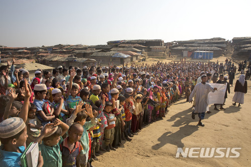 【콕스바자르=AP/뉴시스】로힝야족 난민이 22일 방글라데시 콕스 바자르에 있는 난민촌에서 열린 송환 항의 집회에 참석해 손을 흔들며 미얀마로 돌아가지 않겠다는 구호를 외치고 있다. 2018.01.23