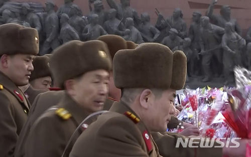 【평양=AP/뉴시스】지난해 2월8일 북한 평양에서 군인과 시민들이 건군절을 맞아 김일성과 김정일 동상에 헌화한 후 경례를 하고 있다. 사진은 동영상을 캡처한 것이다. 이날 평양에서는 건군절 열병식이 열렸다. 2018.2.8