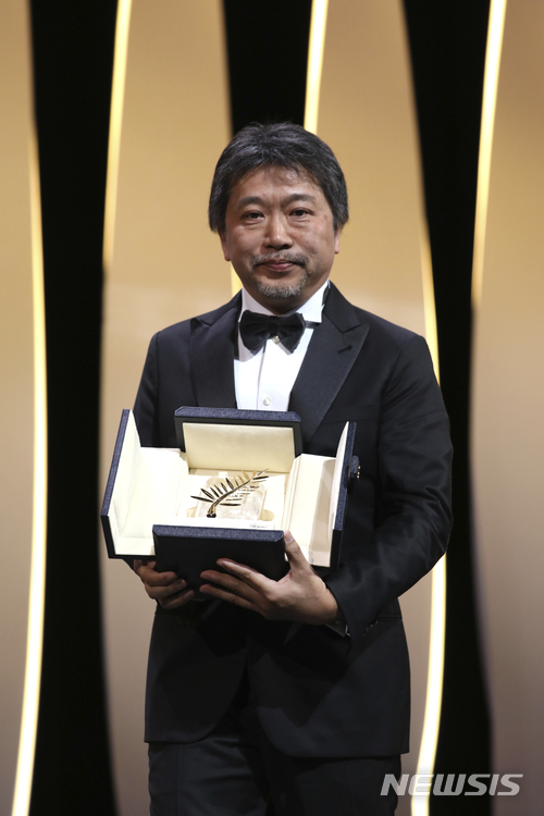 【칸=AP/뉴시스】19일(현지시간) 일본 고레에다 히로카즈 감독이 칸영화제 시상식에서 황금종려상을 받고 포즈를 취하고 있다. 고레에다 감독의 영화 '만비키 가족(Shoplifters)' 이 제71회 칸국제영화제 황금종려상을 수상했다. 2018.05.20 