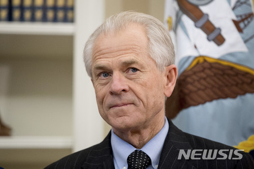 FILE - In this March 31, 2017 file photo, National Trade Council adviser Peter Navarro appears before President Donald Trump arrives to sign executive orders regarding trade in the Oval Office at the White House in Washington. After striking a delicate deal with the United Arab Emirates on rules for airline competition, the Trump administration went to war with itself about what the agreement actually said. White House trade adviser Peter Navarro repeatedly contradicted the State Department’s carefully crafted script. Behind the scenes, a dizzying scene of one-upmanship, word games and subtle subterfuge played out, magnified by lobbyists seeking to exploit divisions within the Trump administration. (AP Photo/Andrew Harnik)
