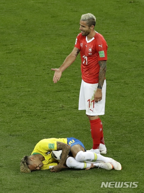 Switzerland&#039;s Valon Behrami reacts as Brazil&#039;s Neymar lies on the ground during the group E match between Brazil and Switzerland at the 2018 soccer World Cup in the Rostov Arena in Rostov-on-Don, Russia, Sunday, June 17, 2018. (AP Photo/Andrew Medichini)