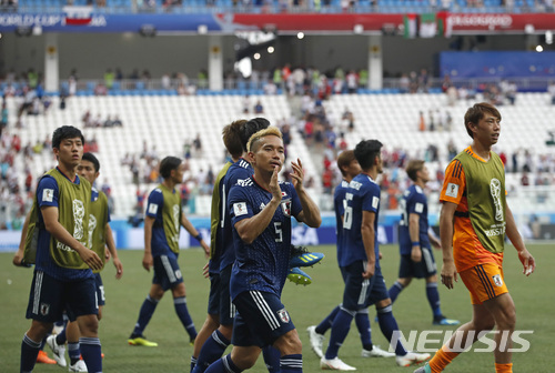 Japanese players applaud supporters after the group H match between Japan and Poland at the 2018 soccer World Cup at the Volgograd Arena in Volgograd, Russia, Thursday, June 28, 2018. Japan lost 1-0, but still qualified for the round of 16. (AP Photo/Darko Vojinovic)