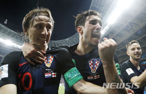 Croatia&#039;s Luka Modric, left, Sime Vrsaljko and Ivan Rakitic, right, celebrate after Croatia&#039;s Mario Mandzukic scored his side&#039;s second goal during the semifinal match between Croatia and England at the 2018 soccer World Cup in the Luzhniki Stadium in Moscow, Russia, Wednesday, July 11, 2018. (AP Photo/Frank Augstein)