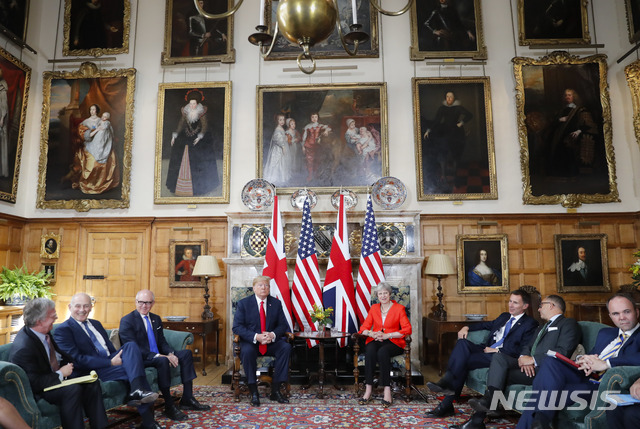U.S. President Donald Trump, centre left, with British Prime Minister Theresa May, centre right are seated during their meeting at Chequers, in Buckinghamshire, England, Friday, July 13, 2018. (AP Photo/Pablo Martinez Monsivais)