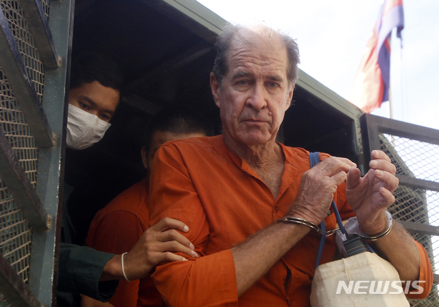 【프놈펜=AP/뉴시스】호주 다큐멘터리 감독 제임스 리켓슨이 29일 수갑을 찬 채 프놈펜 법정에 출두하기 위해 호송차량에서 내리고 있다. 그는 지난해 6월 야당 정치행사를 취재하기 위해 드론을 날렸다는 이유로 체포됐다. 2018.08.31 
