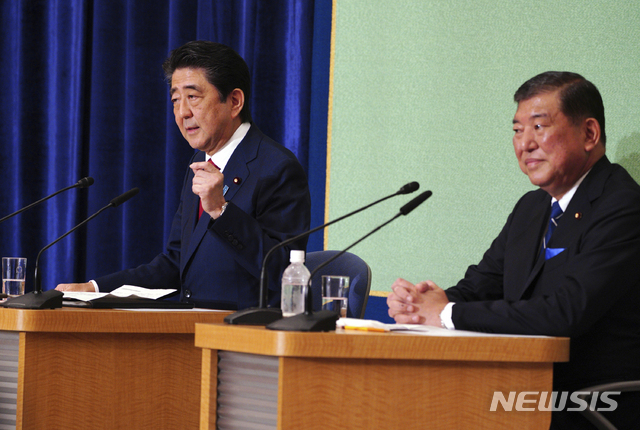 Candidates for president of ruling party Japanese Prime Minister and head of current party president Shinzo Abe, left, and Shigeru Ishiba participate in a debate ahead of Liberal Democratic Party president election in Tokyo Friday, Sept. 14, 2018. Abe is vying for his third re-election as the ruling party leader next week, extending his stay in power to work on his long-cherished ambition, to revise his country&#039;s war-renouncing constitution. (AP Photo/Eugene Hoshiko)