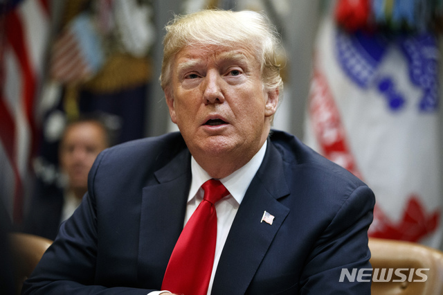 President Donald Trump listens to a reporter's question during a meeting of the President's National Council of the American Worker in the Roosevelt Room of the White House, Monday, Sept. 17, 2018, in Washington. (AP Photo/Evan Vucci)