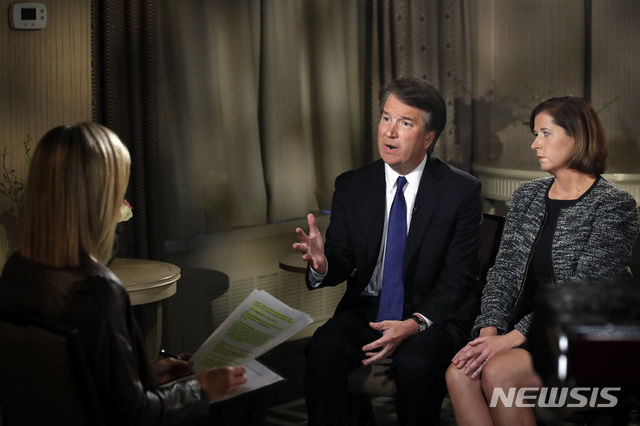 Brett Kavanaugh and his wife Ashley Kavanaugh answer questions during a FOX News interview with Martha MacCallum, Monday, Sept. 24, 2018, in Washington, about allegations of sexual misconduct against the Supreme Court nominee. (AP Photo/Jacquelyn Martin)