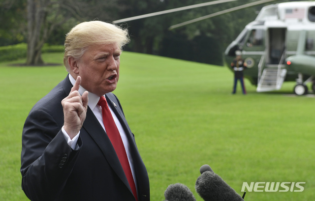 President Donald Trump speaks to reporters on the South Lawn of the White House in Washington, Monday, Oct. 8, 2018, as he heads to Marine One for the short trip to Andrews Air Force Base. Trump is traveling to Florida for the day. (AP Photo/Susan Walsh) 