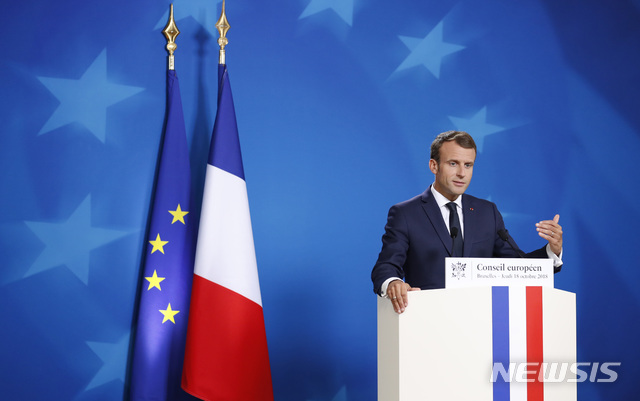 French President Emmanuel Macron speaks during a media conference at an EU summit in Brussels, Thursday, Oct. 18, 2018. EU leaders met for a second day on Thursday to discuss migration, cybersecurity and to try and move ahead on stalled Brexit talks. (AP Photo/Alastair Grant)