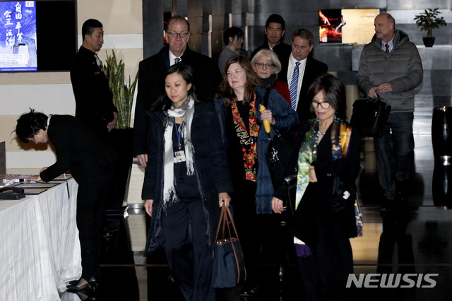 Members of a U.S. trade delegation leave the Westin hotel in Beijing, Monday, Jan. 7, 2019. The U.S. delegation led by deputy U.S. trade representative Jeffrey D. Gerrish arrived in the Chinese capital for a trade talks with China. China sounded a positive note ahead of trade talks this week with Washington, but the two sides face potentially lengthy wrangling over technology and the future of their economic relationship. (AP Photo/Andy Wong)