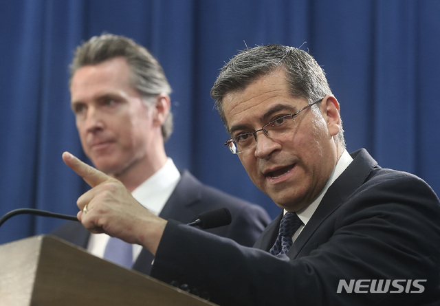 California Attorney General Xavier Becerra, right, accompanied by Gov. Gavin Newsom, said California will probably sue President Donald Trump over his emergency declaration to fund a wall on the U.S.-Mexico border Friday, Feb. 15, 2019, in Sacramento, Calif. Becerra says there is no emergency at the border and Trump doesn&#039;t have the authority to make the declaration. (AP Photo/Rich Pedroncelli)