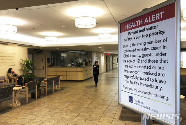 FILE - In this Jan. 25, 2019 file photo a sign prohibiting all children under 12 and unvaccinated adults stands at the entrance to PeaceHealth Southwest Medical Center in Vancouver, Wash. The Washington House has approved a measure Tuesday, March 5, 2019, that would remove parents&#039; ability to claim a personal or philosophical exemption to vaccinating their school-age children for measles. The vote comes in the midst of an outbreak that has sickened 71 people in the state. (AP Photo/Gillian Flaccus, File)