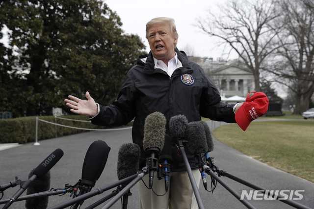 President Donald Trump talks with reporters outside the White House before traveling to Alabama to visit areas affected by the deadly tornadoes, Friday, March 8, 2019, in Washington. (AP Photo/ Evan Vucci)
