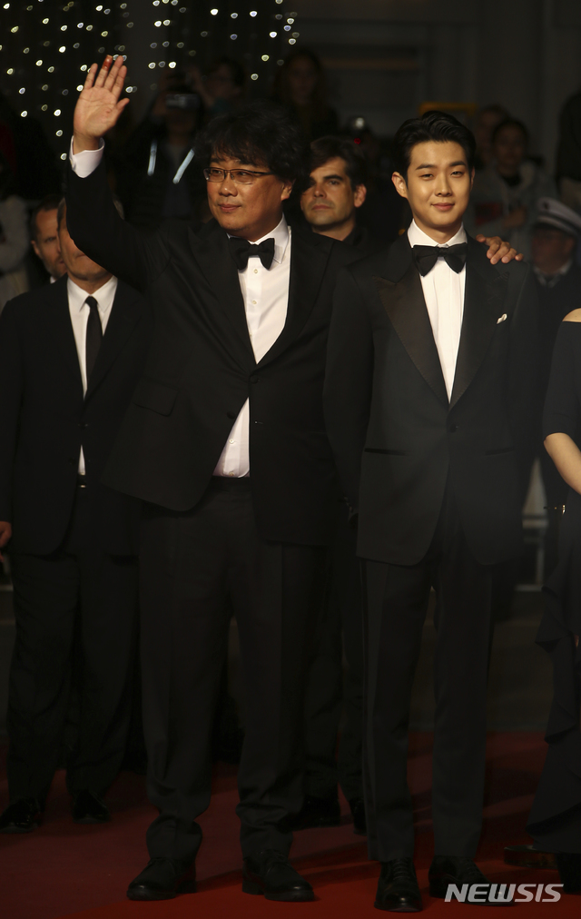 Director Bong Joon-ho, left, and actor Choi Woo-shik pose for photographers upon arrival at the premiere of the film 'Parasite' at the 72nd international film festival, Cannes, southern France, Tuesday, May 21, 2019. (Photo by Joel C Ryan/Invision/AP) 