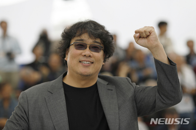 Director Bong Joon-ho poses for photographers at the photo call for the film &#039;Parasite&#039; at the 72nd international film festival, Cannes, southern France, Wednesday, May 22, 2019. (AP Photo/Petros Giannakouris)