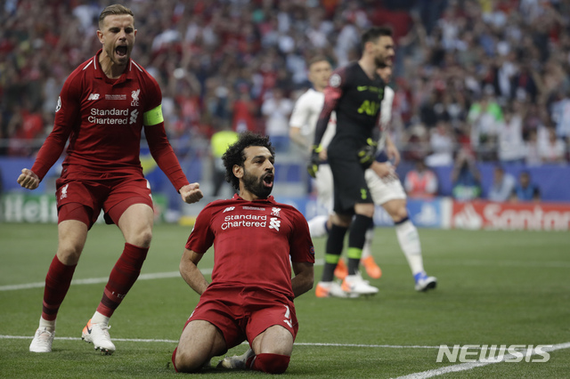 Liverpool&#039;s Mohamed Salah, bottom, celebrates after scoring his side&#039;s opening goal during the Champions League final soccer match between Tottenham Hotspur and Liverpool at the Wanda Metropolitano Stadium in Madrid, Saturday, June 1, 2019. (AP Photo/Felipe Dana)