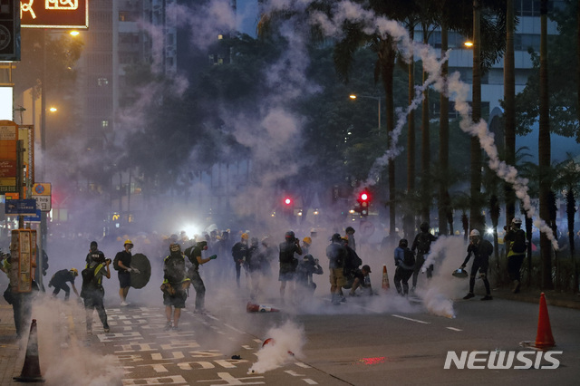 【홍콩=AP/뉴시스】홍콩 시위대들이 11일 홍콩 시내에서 송환법 반대를 외치며 10주째 주말 시위를 이어간 가운데 강제해산을 위해 홍콩 경찰이 발사한 최루탄 가스 연기가 자욱하다. 2019.08.11