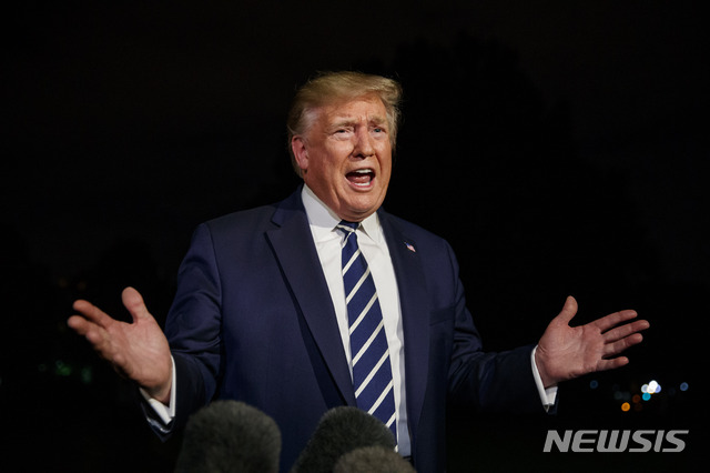 President Donald Trump speaks with reporters as he walks to Marine One on the South Lawn of the White House, Friday, Aug. 23, 2019, in Washington. Trump is en route to the G-7 summit in France. (AP Photo/Alex Brandon)