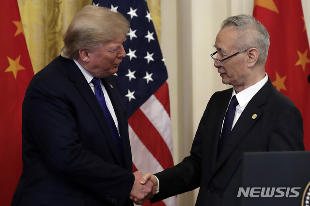 President Donald Trump shakes hands with Chinese Vice Premier Liu He, in the East Room of the White House, Wednesday, Jan. 15, 2020, in Washington, before they signed a trade agreement. (AP Photo/Evan Vucci)