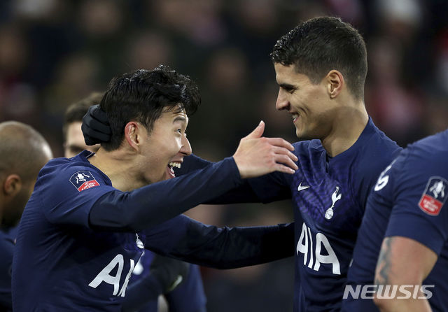 Tottenham Hotspur&#039;s Son Heung-min, left, celebrates scoring his side&#039;s first goal of the game with team-mate Erik Lamela during the FA Cup fourth round soccer match between Southampton and Tottenham Hotspur at St Mary&#039;s Stadium, Southampton, England. Saturday, Jan. 25, 2020. (Steven Paston/PA via AP)